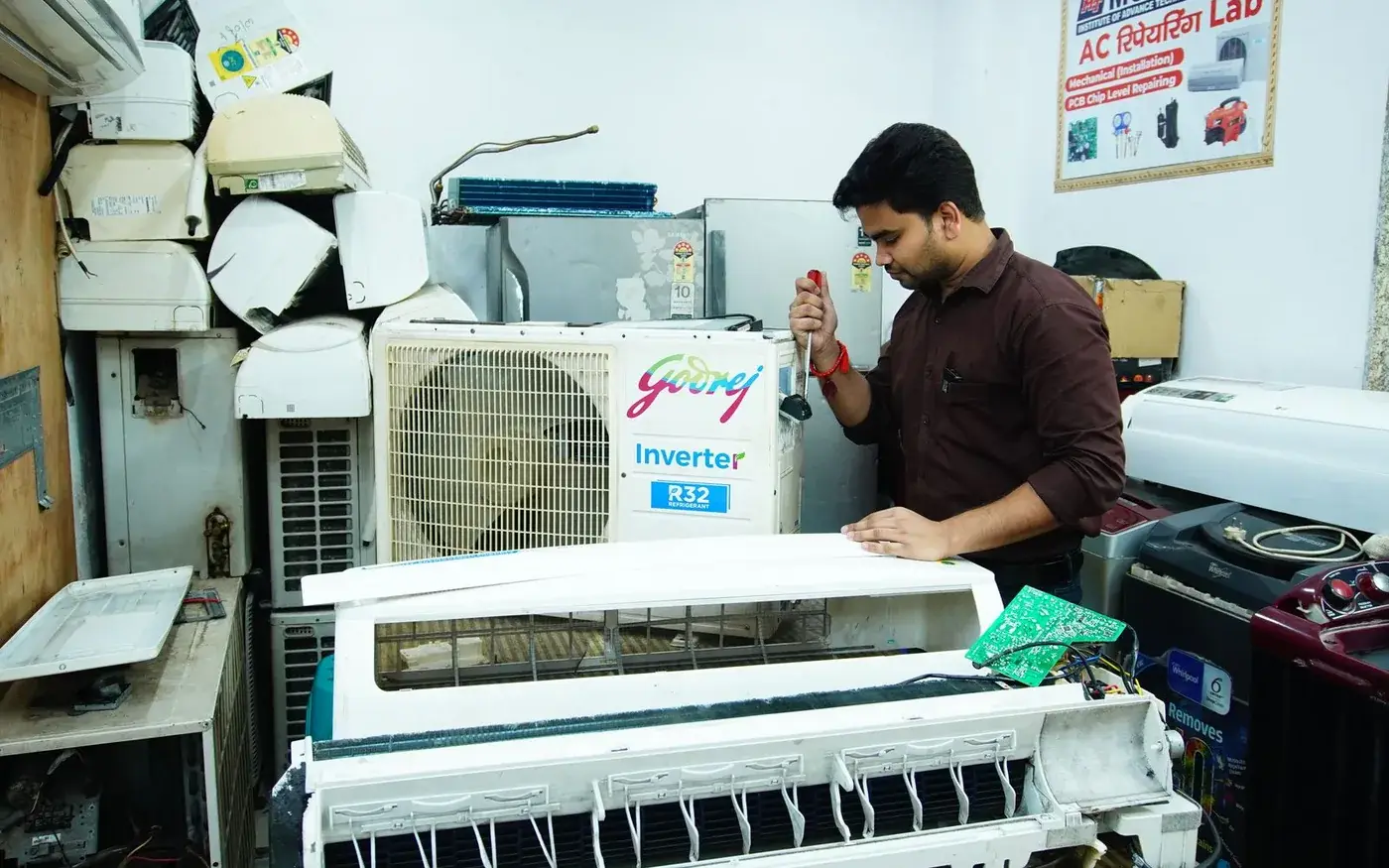 Technician servicing an open air-conditioning indoor unit