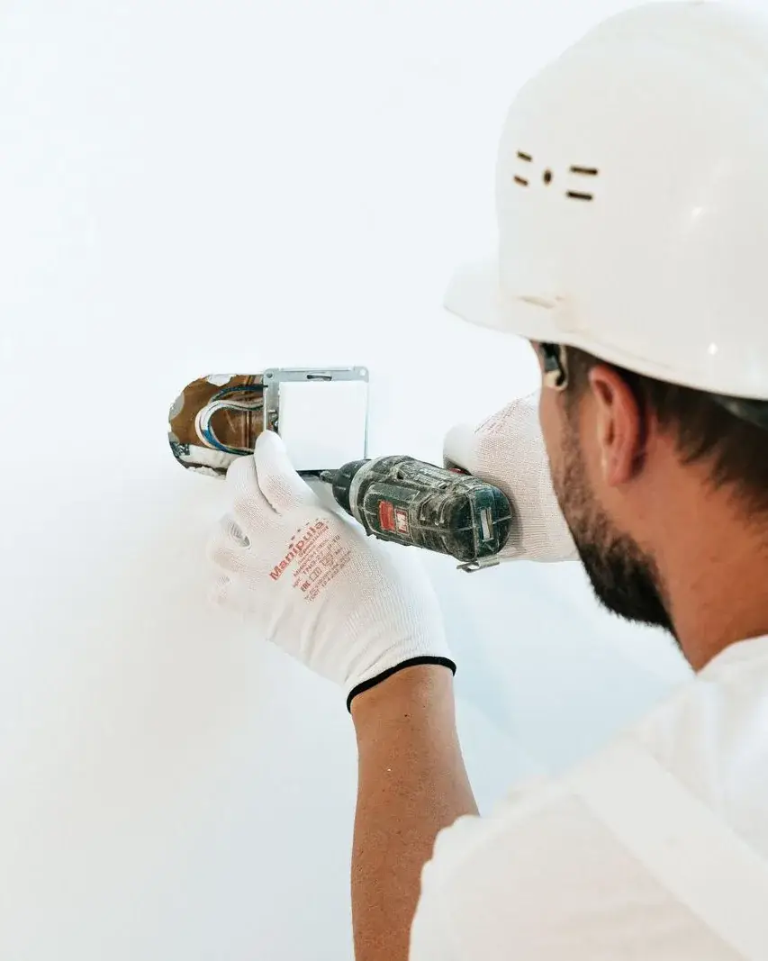 Technician replacing a wall switch